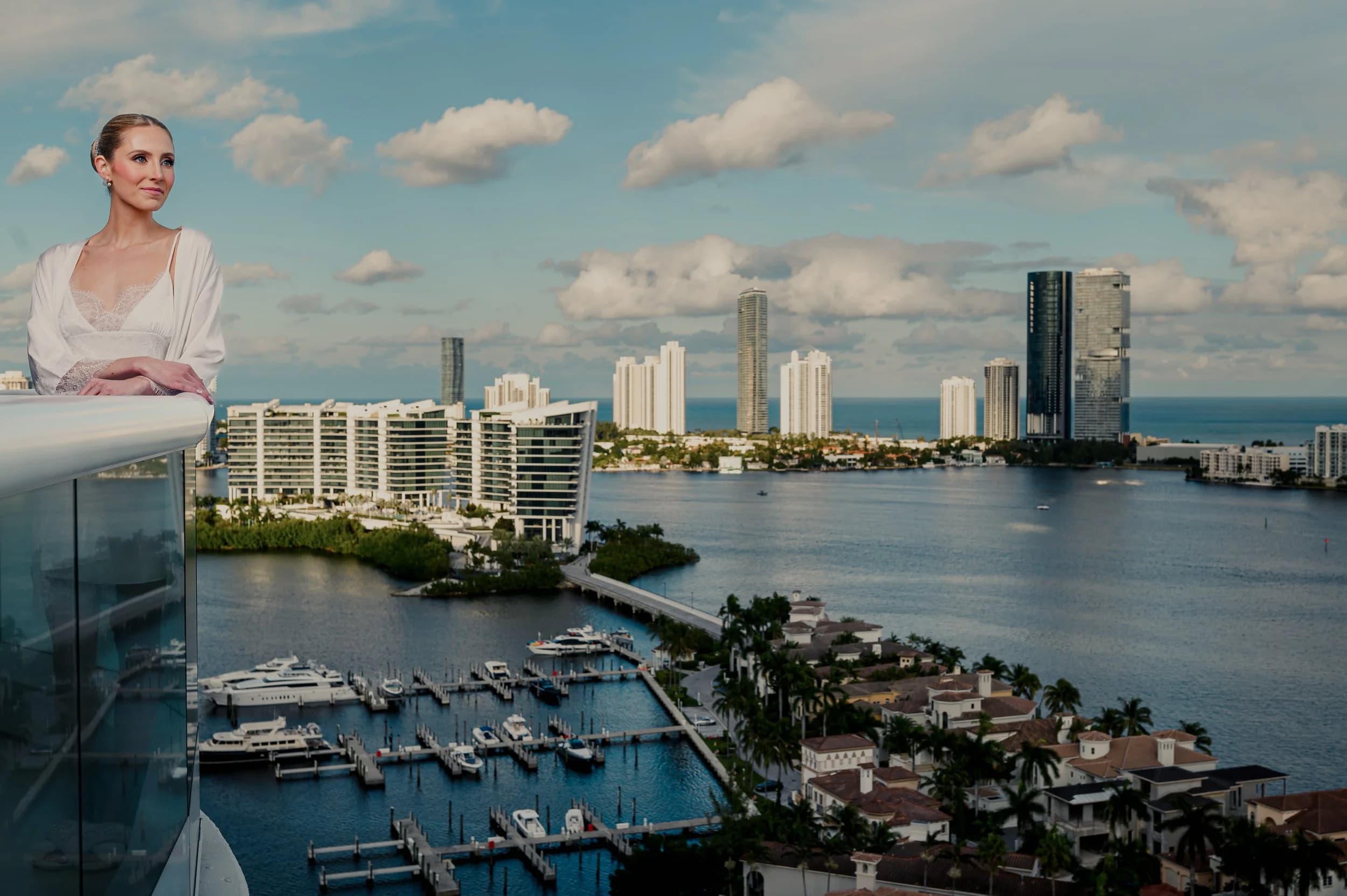 Portrait of a woman on a balcony with the Miami skyline behind her, by David Moreno